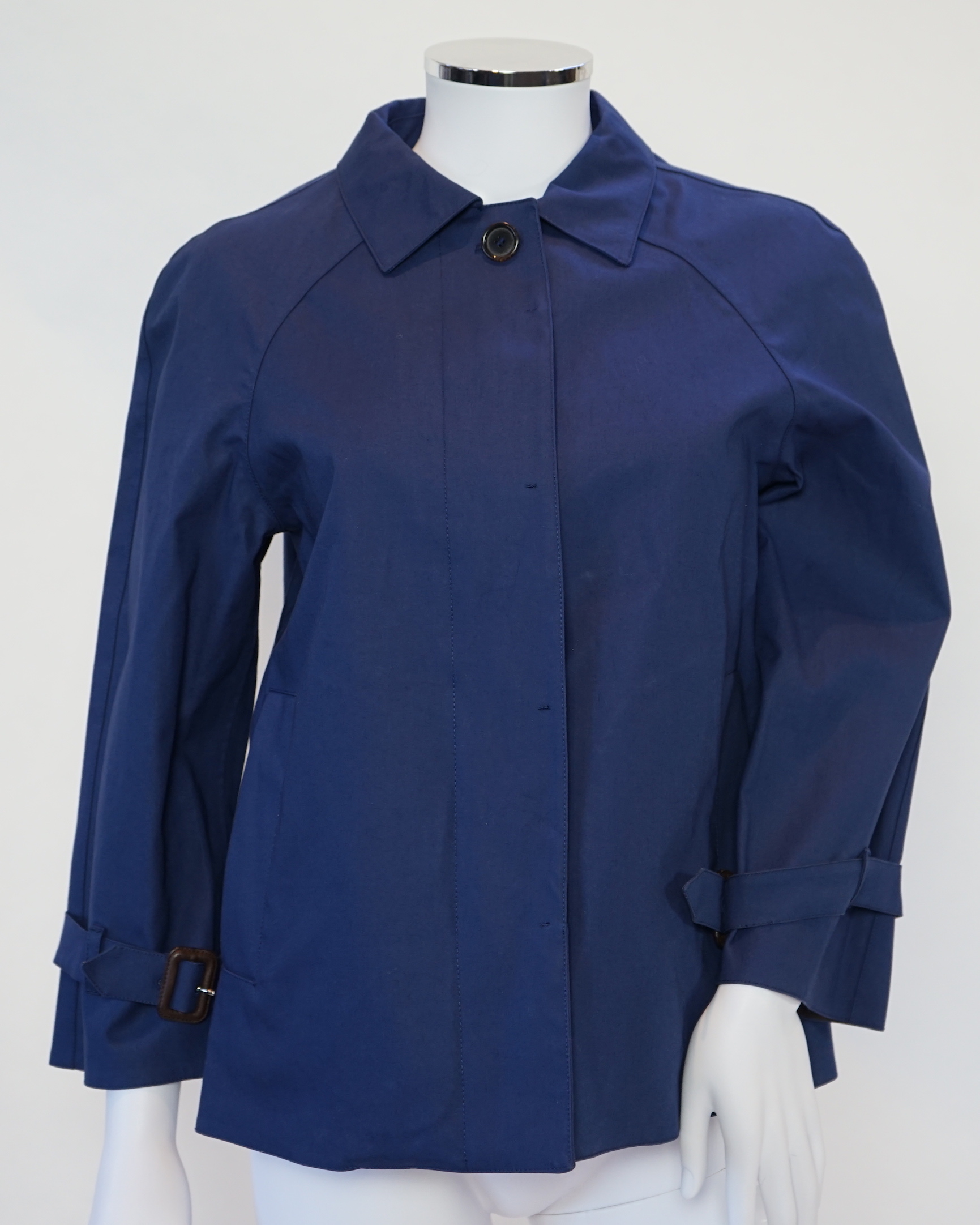 A Prada black A line wool skirt with silver embellishment on the pockets, a blue cotton canvas short swing raincoat and a black pair of wool suit trousers, all size 42